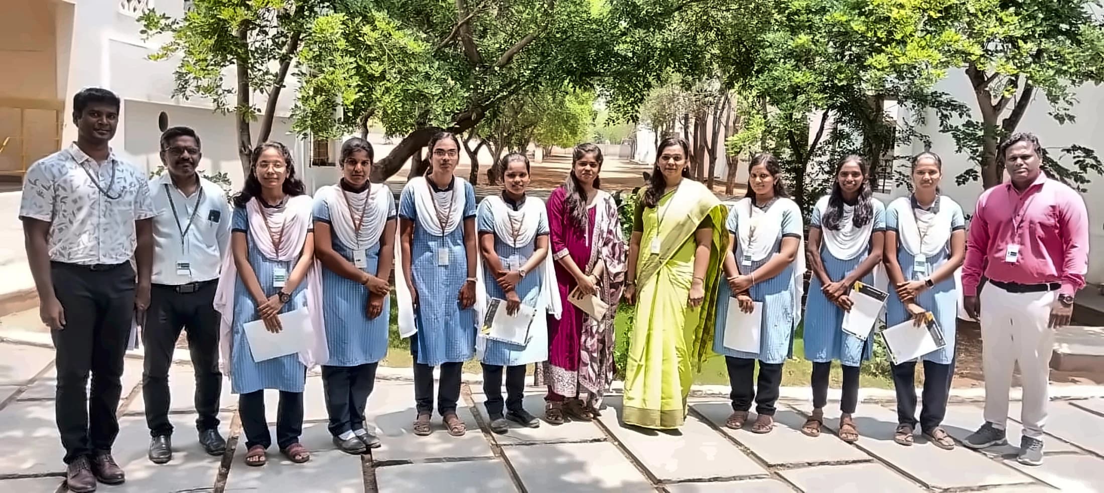 A full student cohort with faculty on campus after the programme