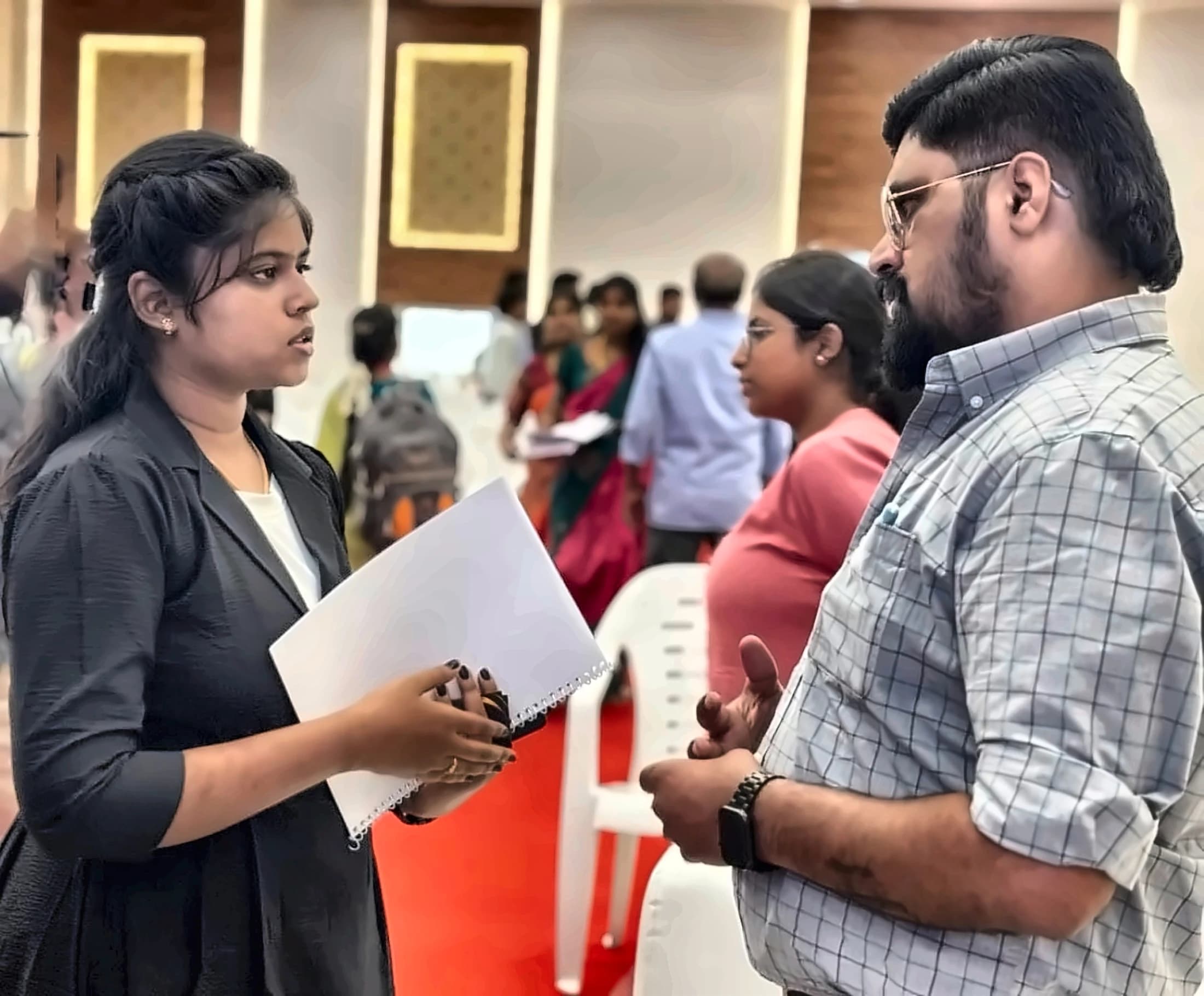 S.N.Rathnadevi in conversation at an industry event, notes in hand